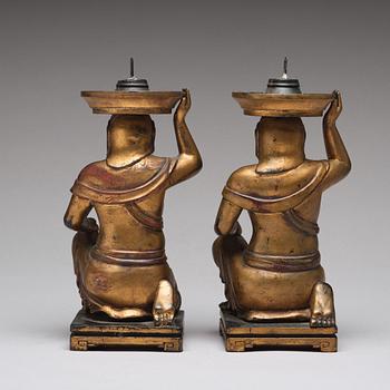 A pair of gilt lacquered candle holders, late Qing dynasty.