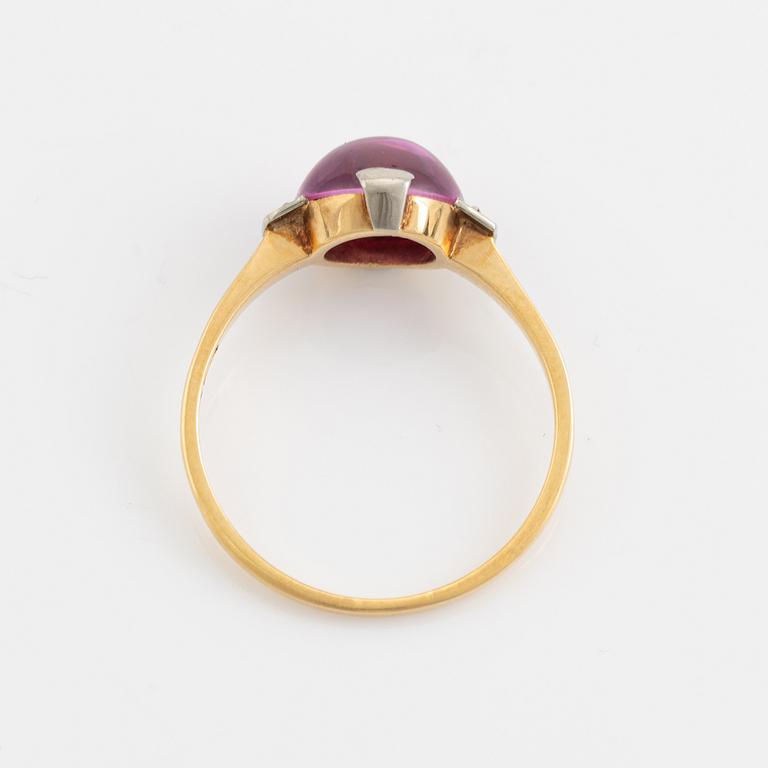 18K gold and cabochon cut syntehtic pink sapphire.