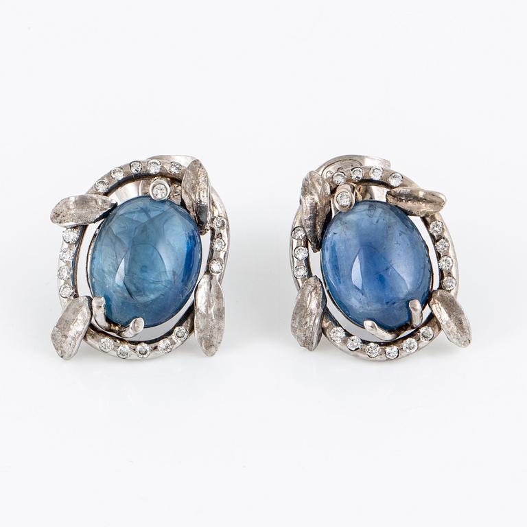 Cabochon-cut sapphire and brilliant-cut diamond earrings.