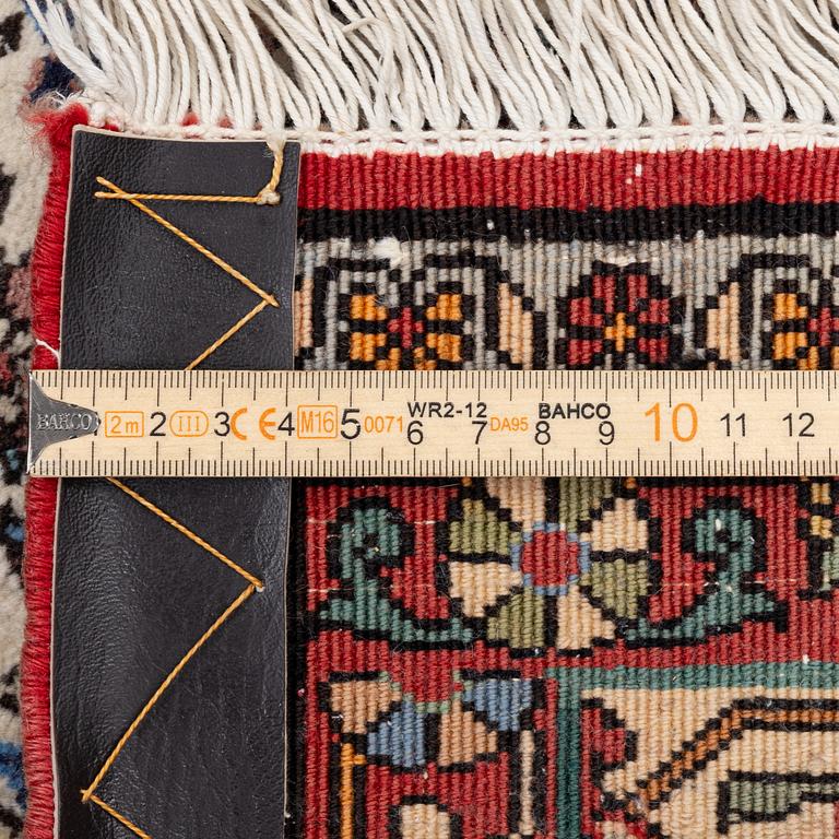 An oriental rug, approx. 238 x 174 cm.