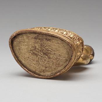 A gilt copper alloy figure of Akshobhya, Tibet, 16th Century.