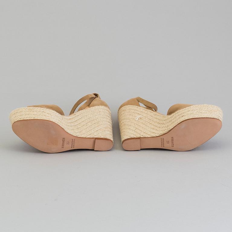 A beige suede platform sandals by Hermès.