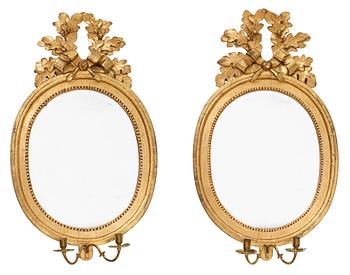 A very similar pair of Gustavian two-light girandole mirrors by N. Meunier.