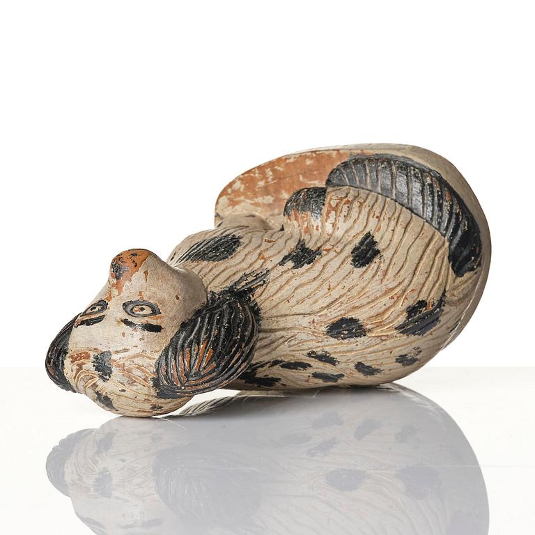 A Swedish wooden folk-art sculpture depicting a 'Staffordshire dog' ceramic figurine, 19th century.