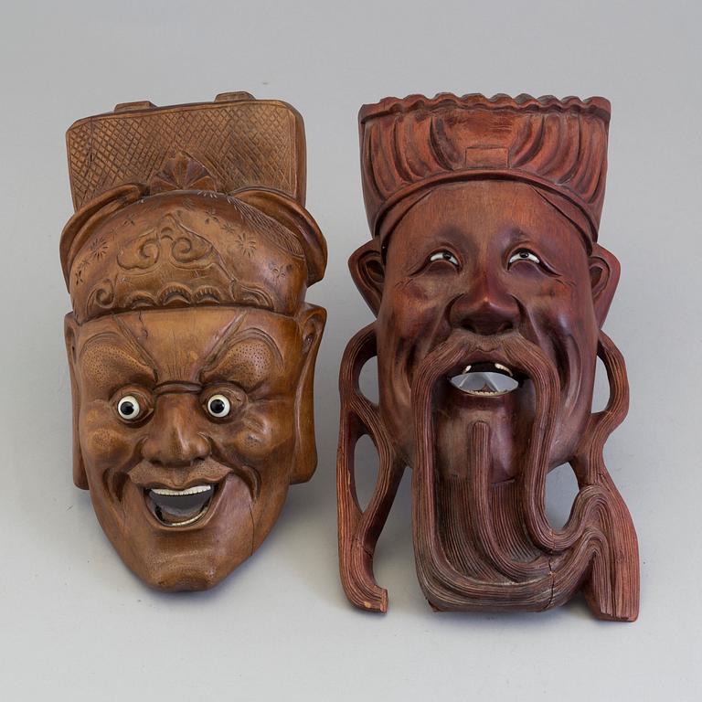 Two wooden south east asian masks, 20th century.