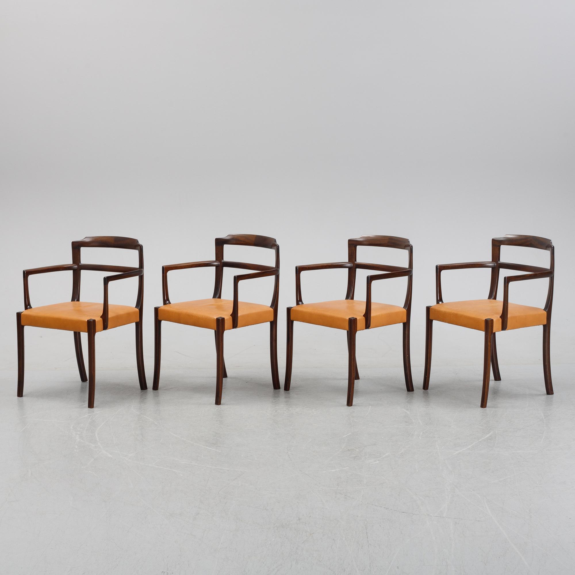 A set of four black stained beech tree arm chairs with leather upholstery, second half of the 20th century.