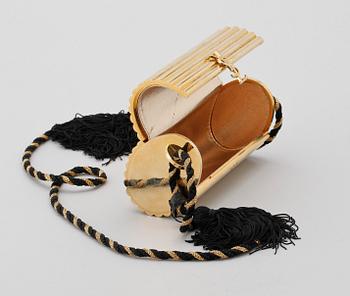 A golden metal evening bag by Yves Saint Laurent.