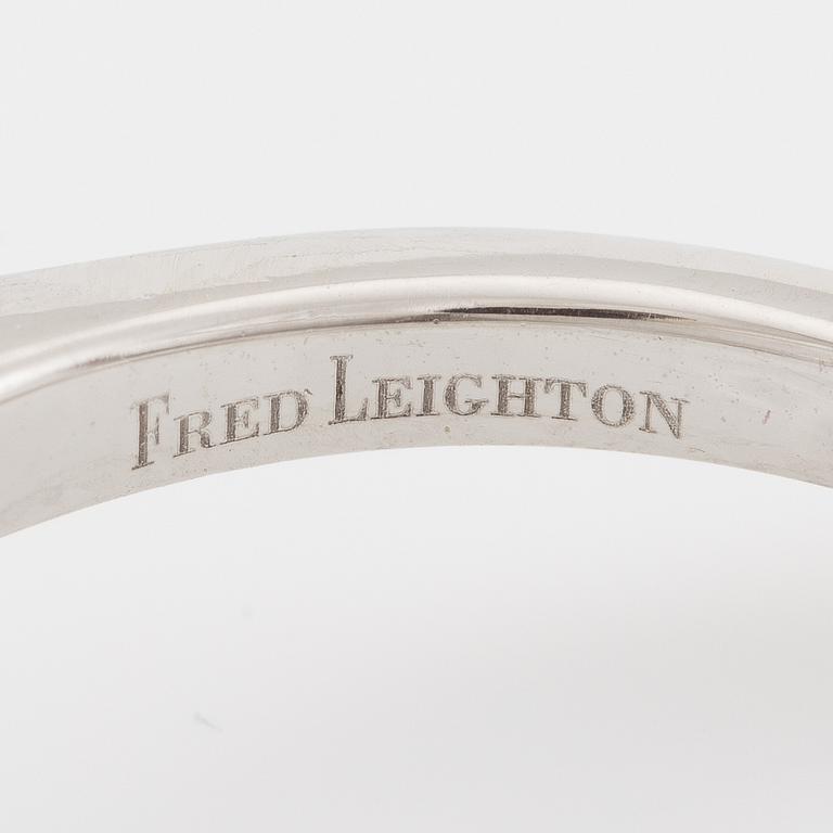 Ring, Fred Leighton platinum with an oval faceted tanzanite and fancy-cut diamonds.