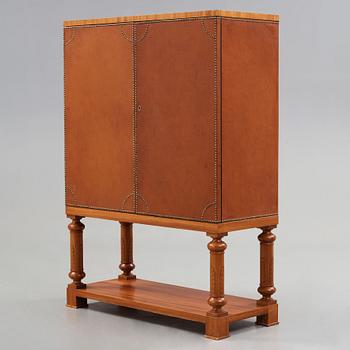 Otto Schulz, Boet, Gothenburg, probably, a cabinet covered with brown leather, dated 1942.