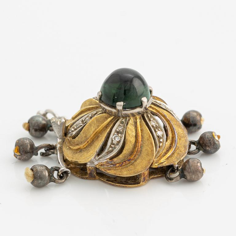 A clasp for a three strand necklace.