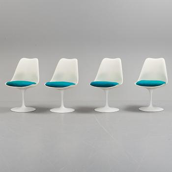 A "Tulip" table and four chairs by Eero Saarinen for Knoll International.