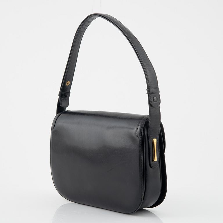 Gucci, a black leather bag.