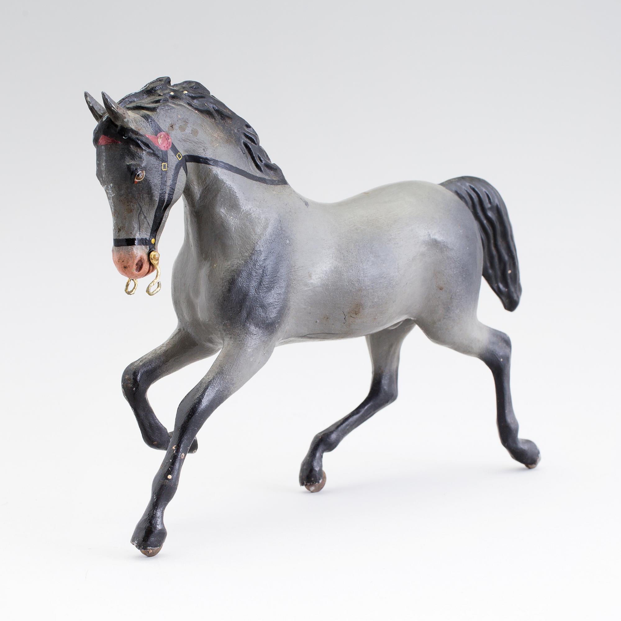 A painted tinplate toy horse ca year 1900.