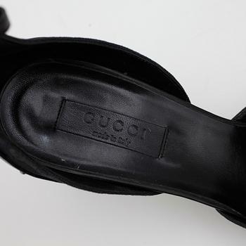 GUCCI, a pair of black monogram canvas lady's shoes.