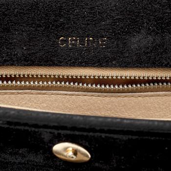 CÈLINE, a black suede handbag.