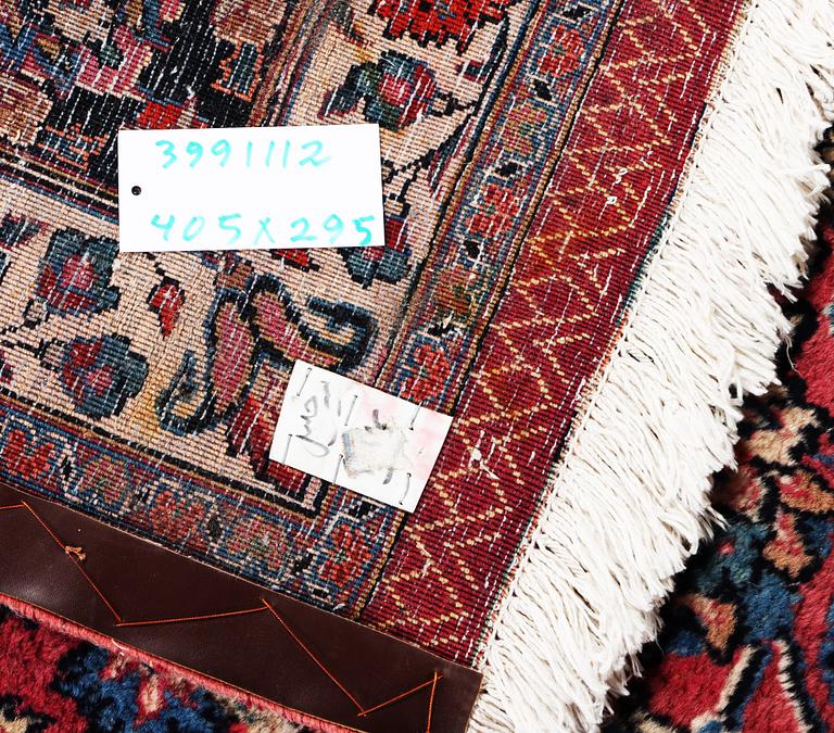 An antique Mashad carpet, signed Saber, c. 405 x 295 cm.