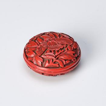 A Chinese red lacquer box with cover and a sculptured nephrite plaque, 20th Century.