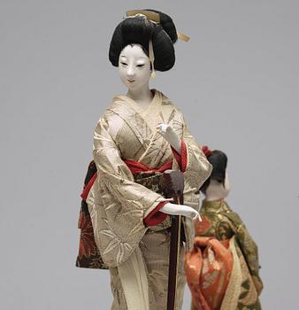 Two Japanese dolls and a box with minitures, 20th Century.