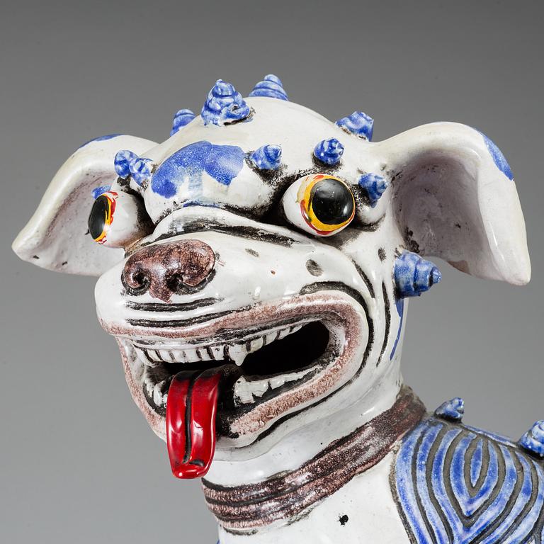 A large Chinese ceramic tile sculpture of a buddhist lion, 20th century.