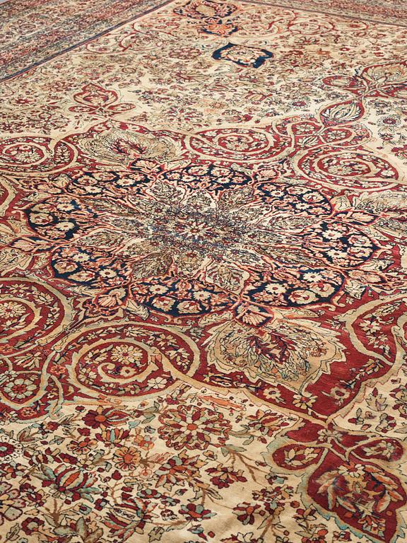 A carpet, an antique Kerman Laver, ca 677-688,5 x 510,5-526 cm.