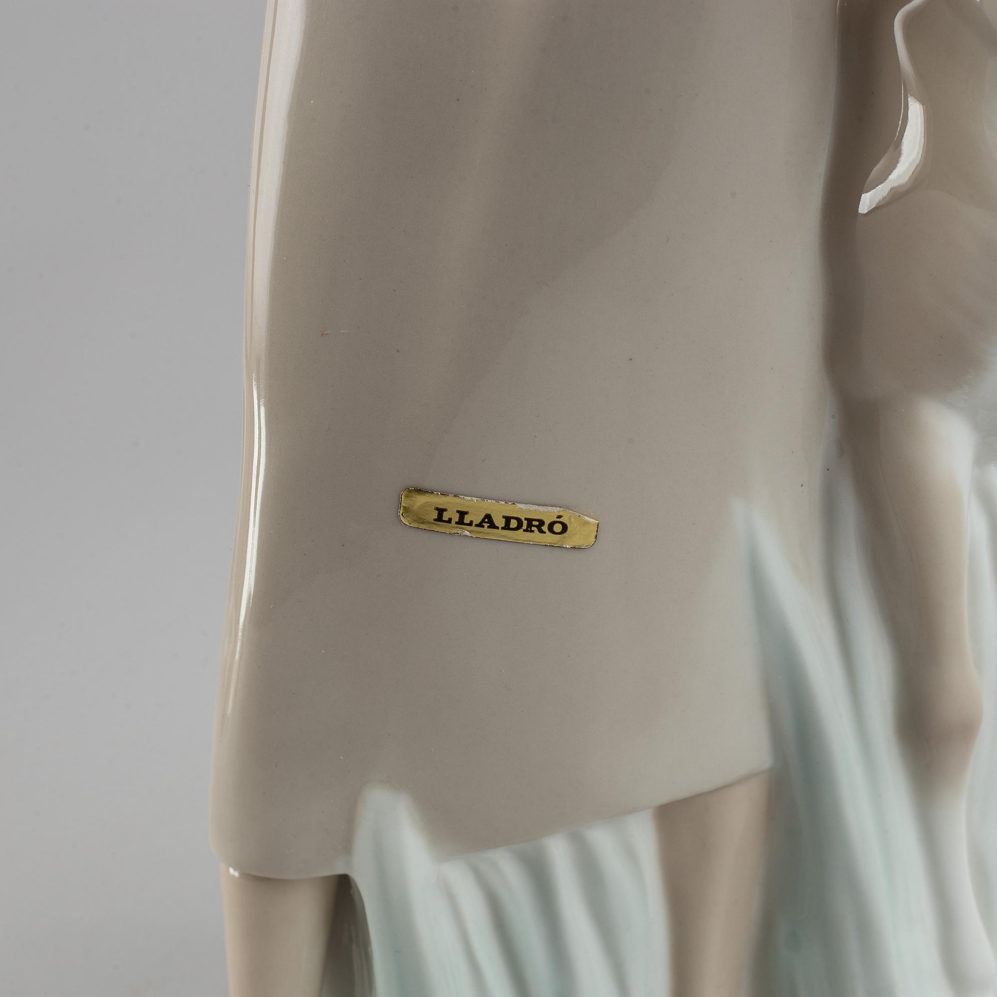 A Lladro porcelain figure of a lady with a dog, Spain, 20th Century.