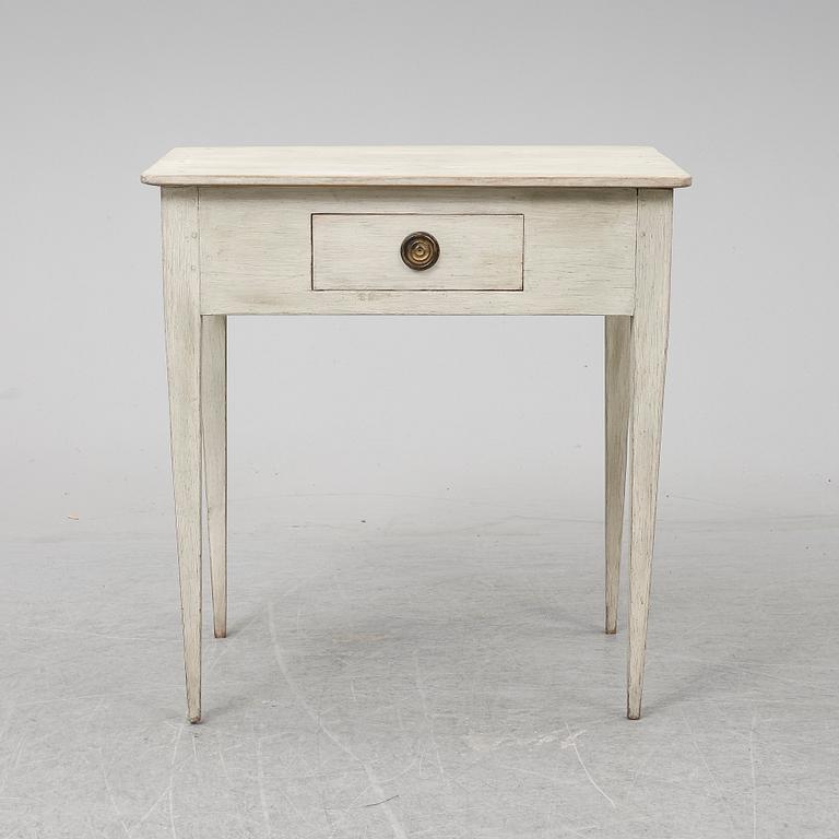 An early 19th Century painted table with a drawer.