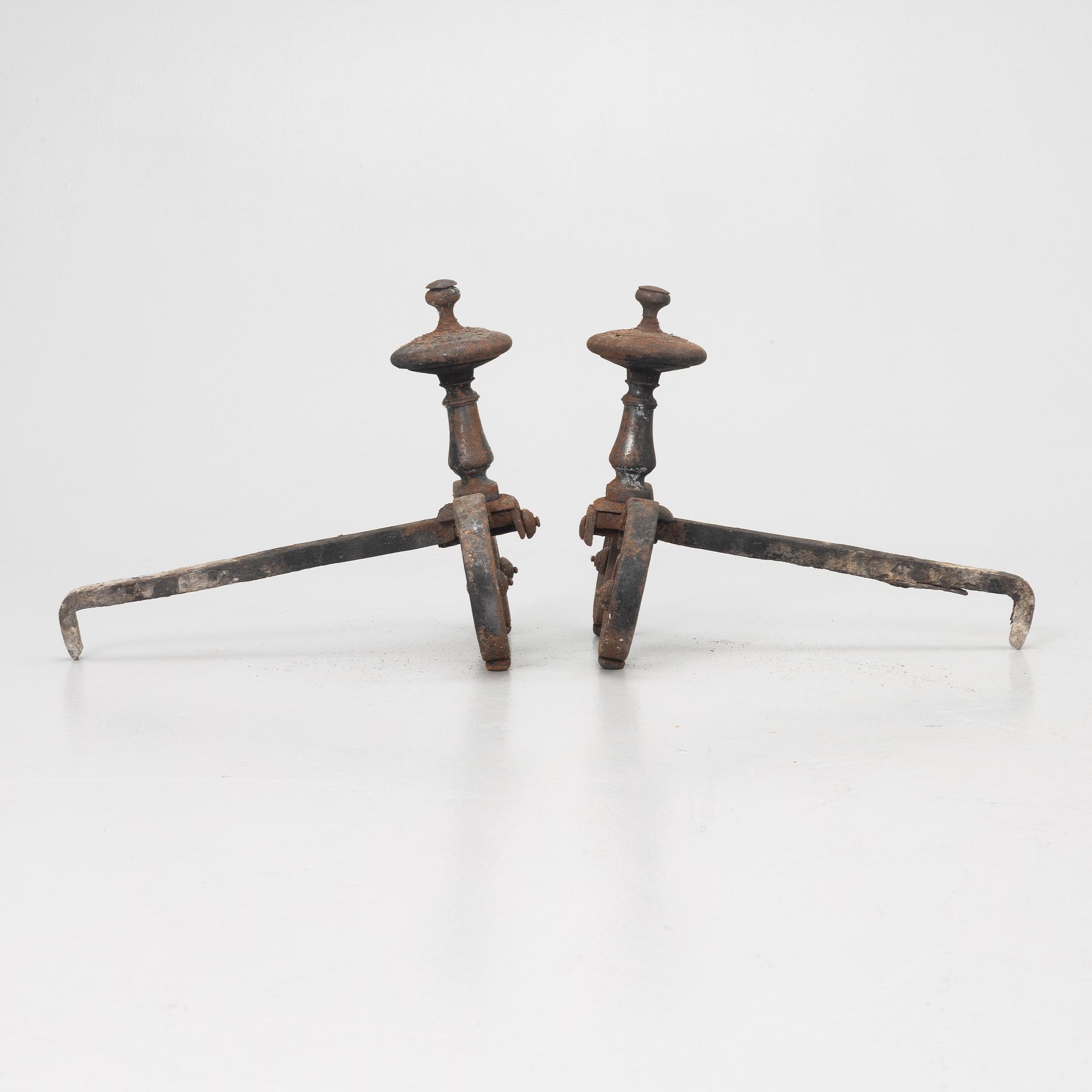A pair of wrought iron fire dogs.