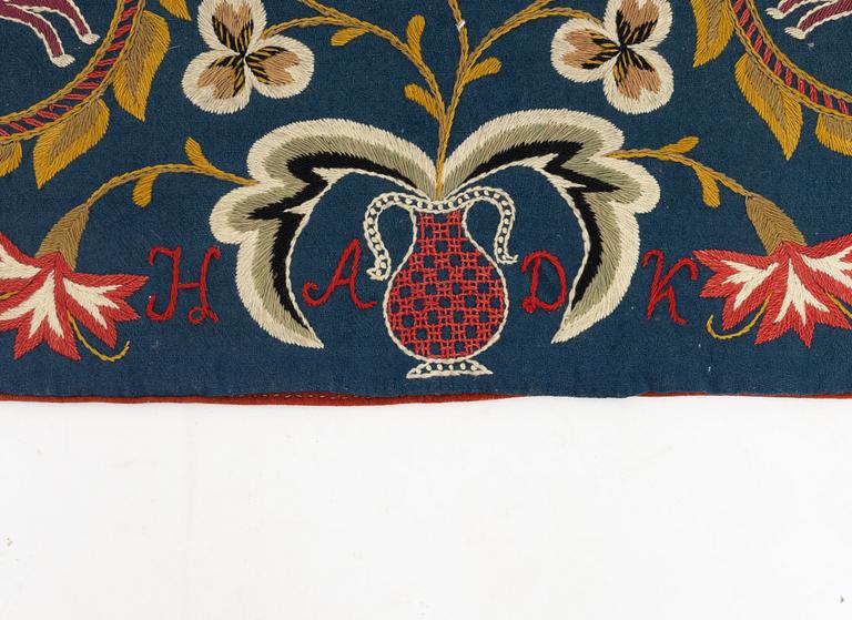 An embroidered Carriage cushion, c 102 x 48 cm Wemmenhög district, southern Skåne, first quarter of the 19th century.