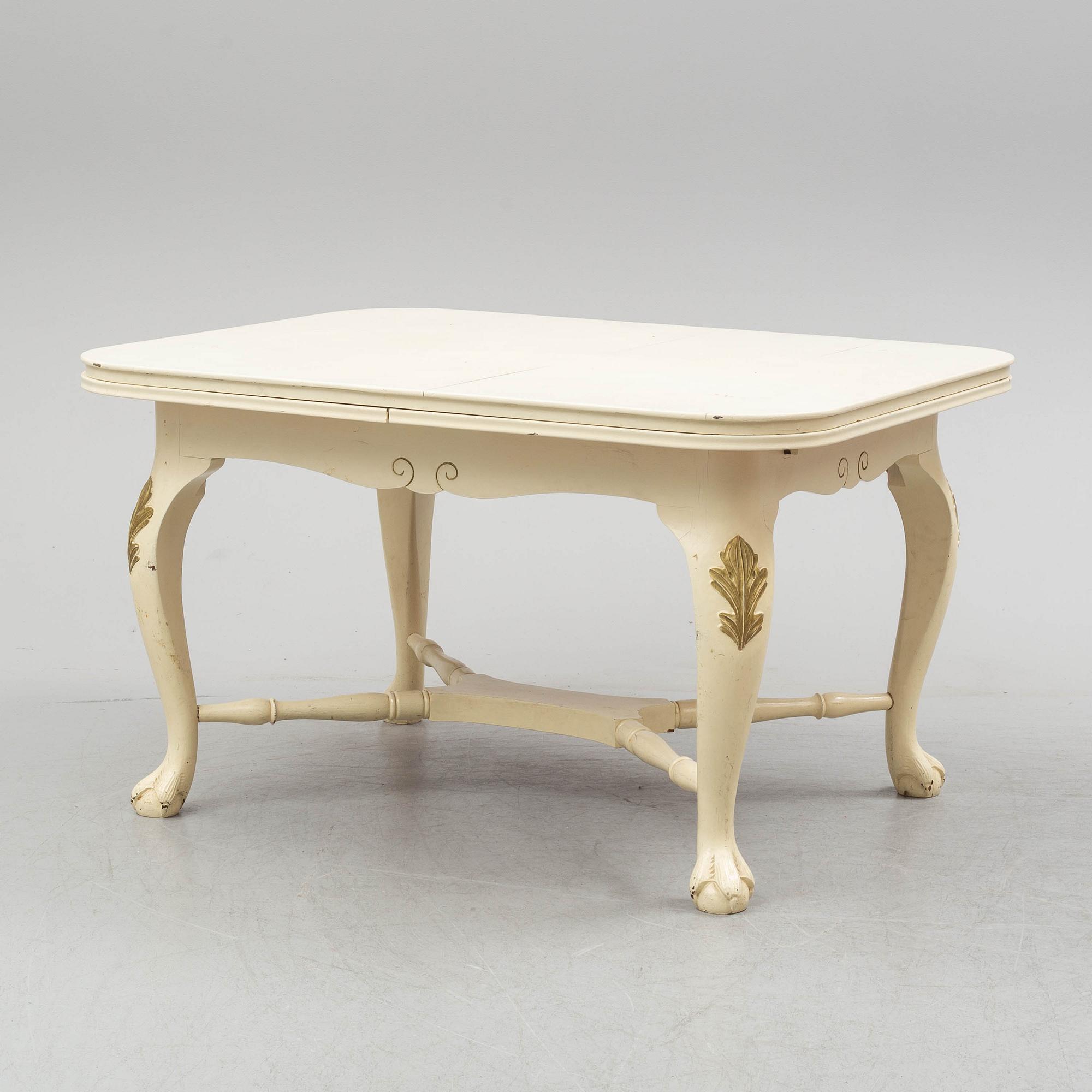 A dining table and six chairs, rococo style, mid 20th century.
