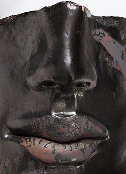 Hertha Hillfon, a black glazed stoneware wall sculpture in two parts of a face and a sky, executed in her own studio, Stockholm 1960s.