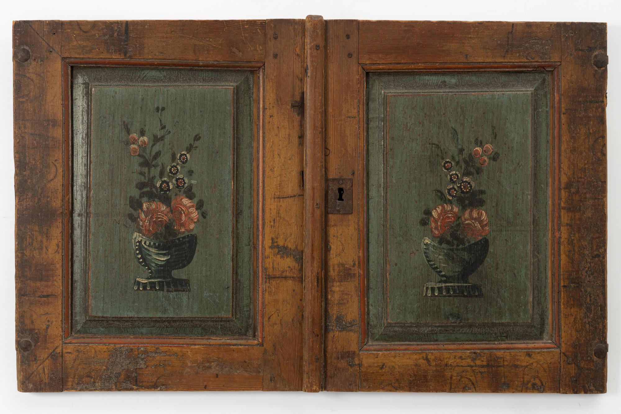 A pair of folk-art cabinet doors mounted as a painting, first part 19th century.