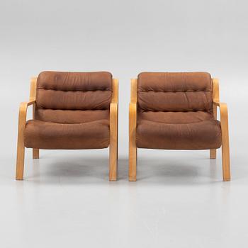 A pair of armchairs, Dux, Sweden, late 20th century.