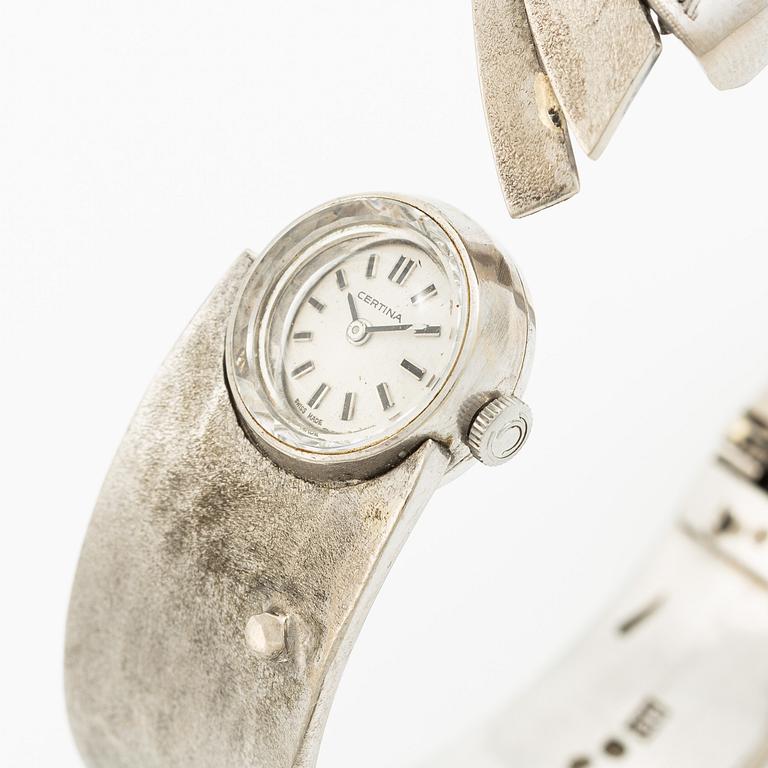 Aftonklocka/armring, Bo Dolk, 18K vitguld med briljantslipade diamanter, 1970-tal.