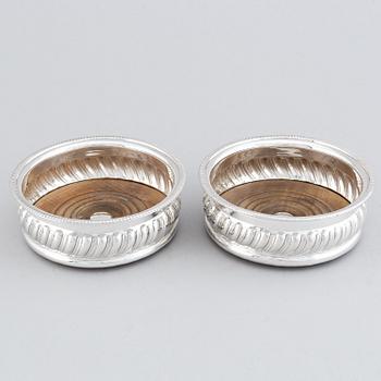 A pair of silver plated coasters.