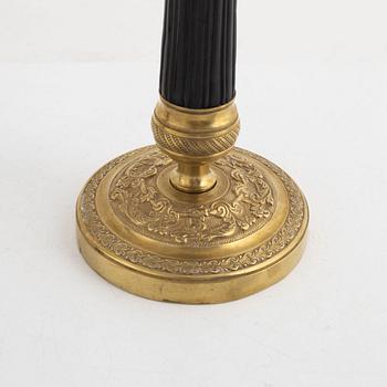 A pair of brass candle sticks, late empire, mid 19th century.