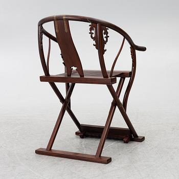 A Chinese hardwood folding chair, 20th century.