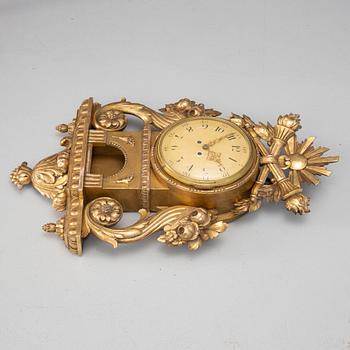 A Gustavian style wall clock, circa 1900.