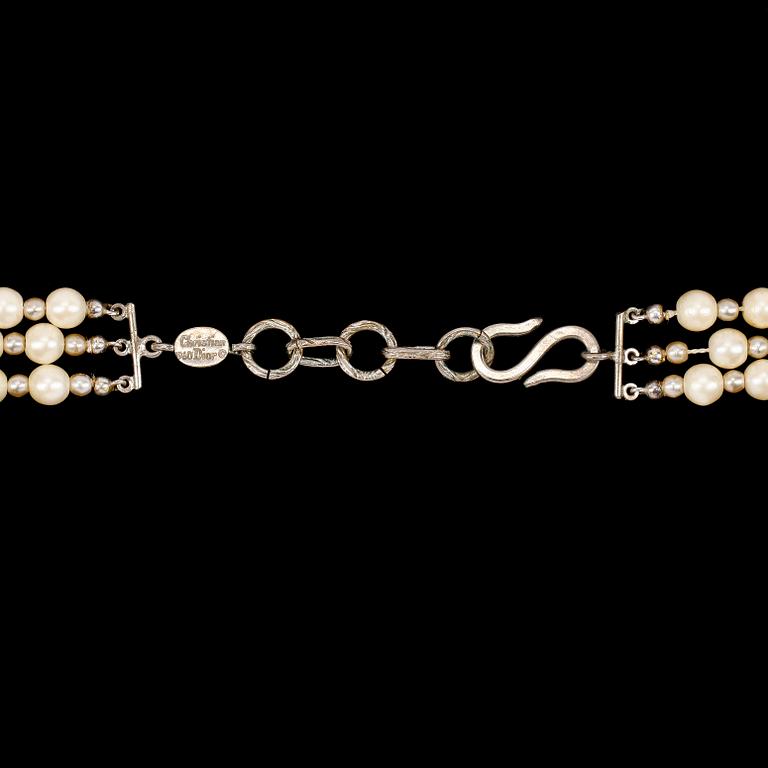 A necklace by Christian Dior with three strand decorative pearls.