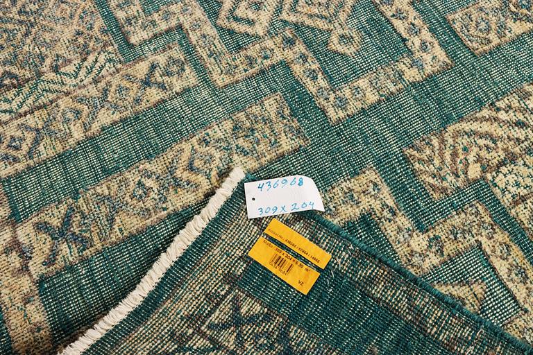 An oriental carpet with relief pattern, c. 309 x 204 cm.