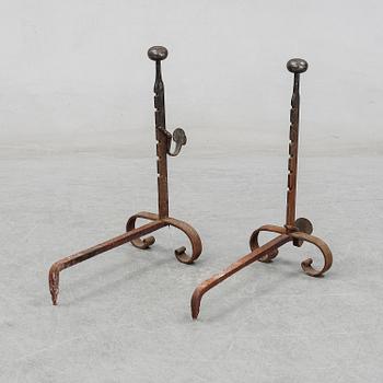 A pair of cast iron fire dogs, 20th Century.