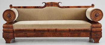 430. A mahogny veneer Empire sofa. 19th Century.