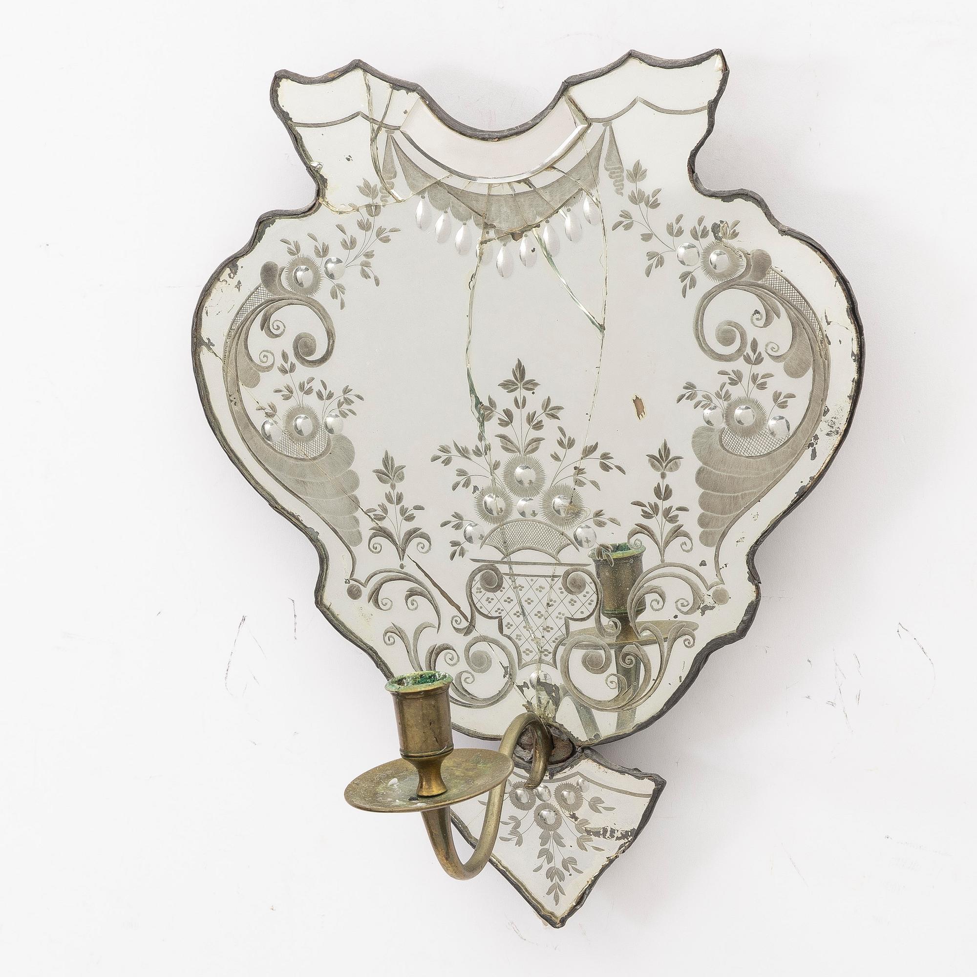 A North European rococo one-branch engraved glass girandole mirror, mid 18th century.