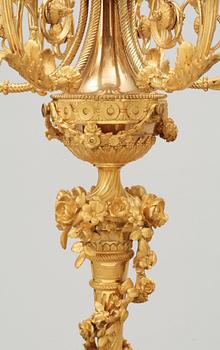 A pair of Louis XVI-style 19th century seven-light candelabra.