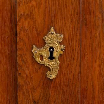 A mid 18th century rococo oak cabinet.