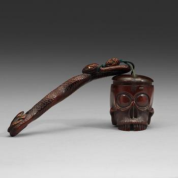 A Japanese bamboo box in the form of a skull with snake, Meiji period (1868-1912).