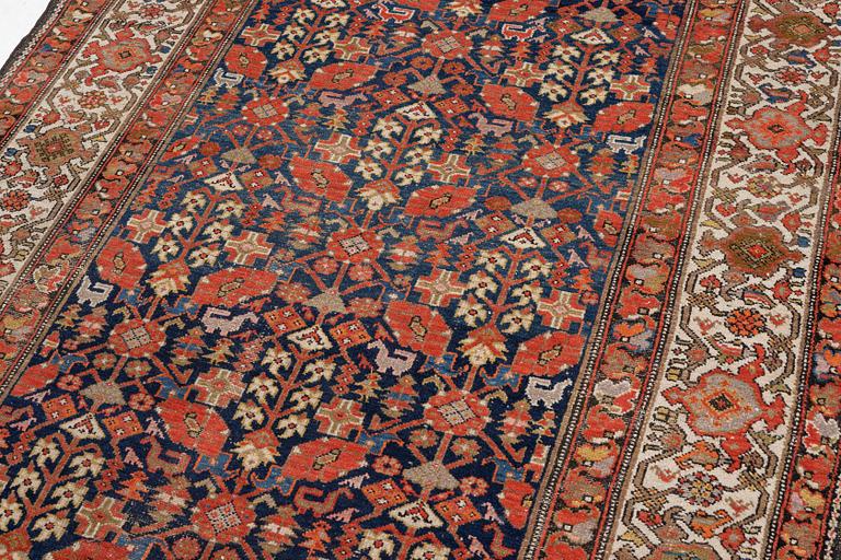 An antique Malayer carpet, west persia c 402 x 178 cm.