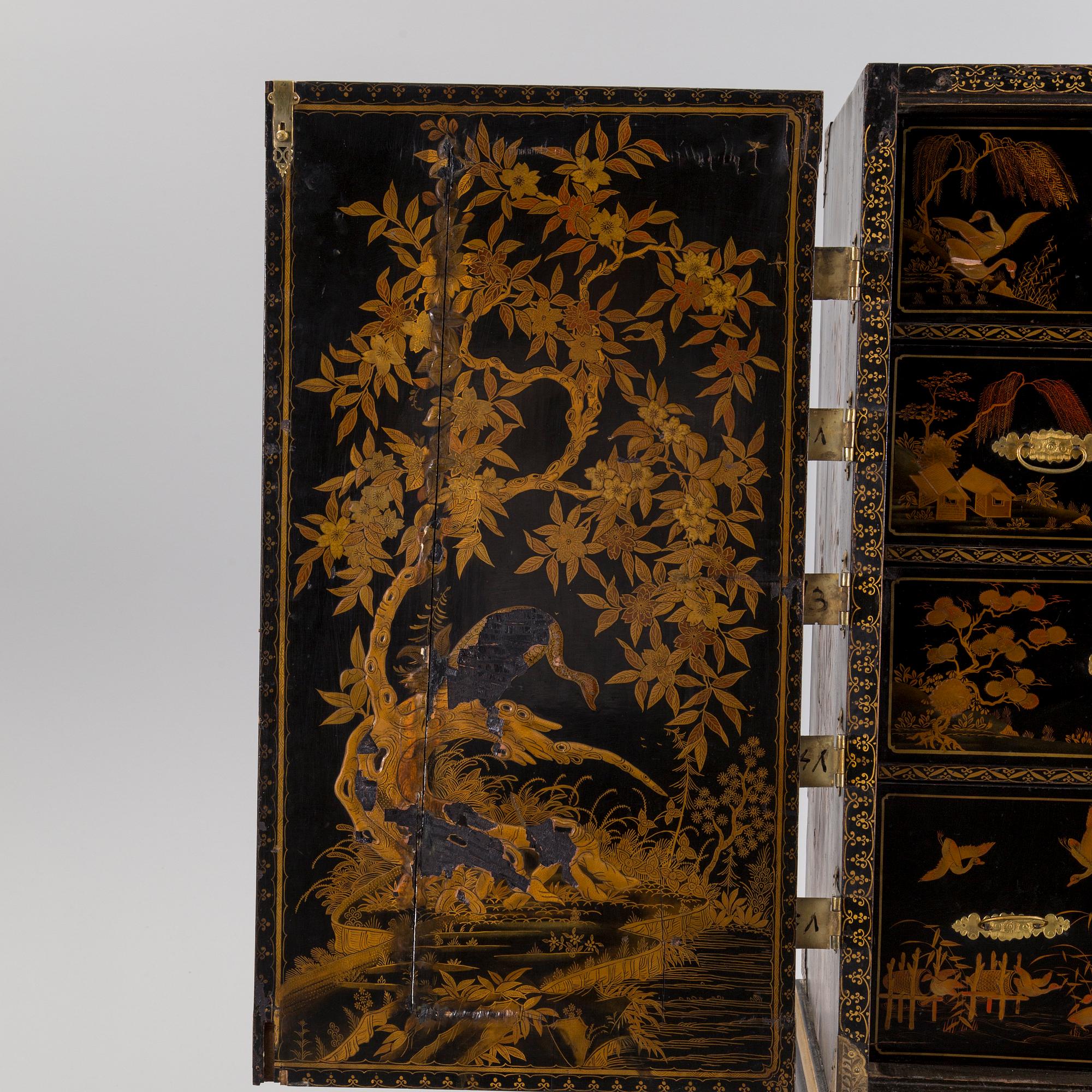 AN early 18TH CENTURY PROBABLY ENGLISH Japanned laquer cabinet on stand.