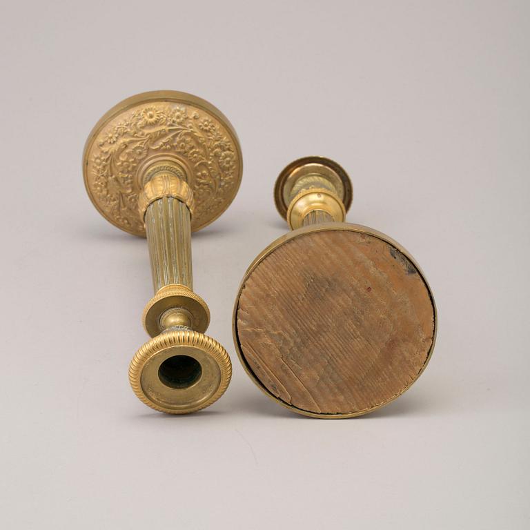 A pair of early 19th century ormolu candlesticks.