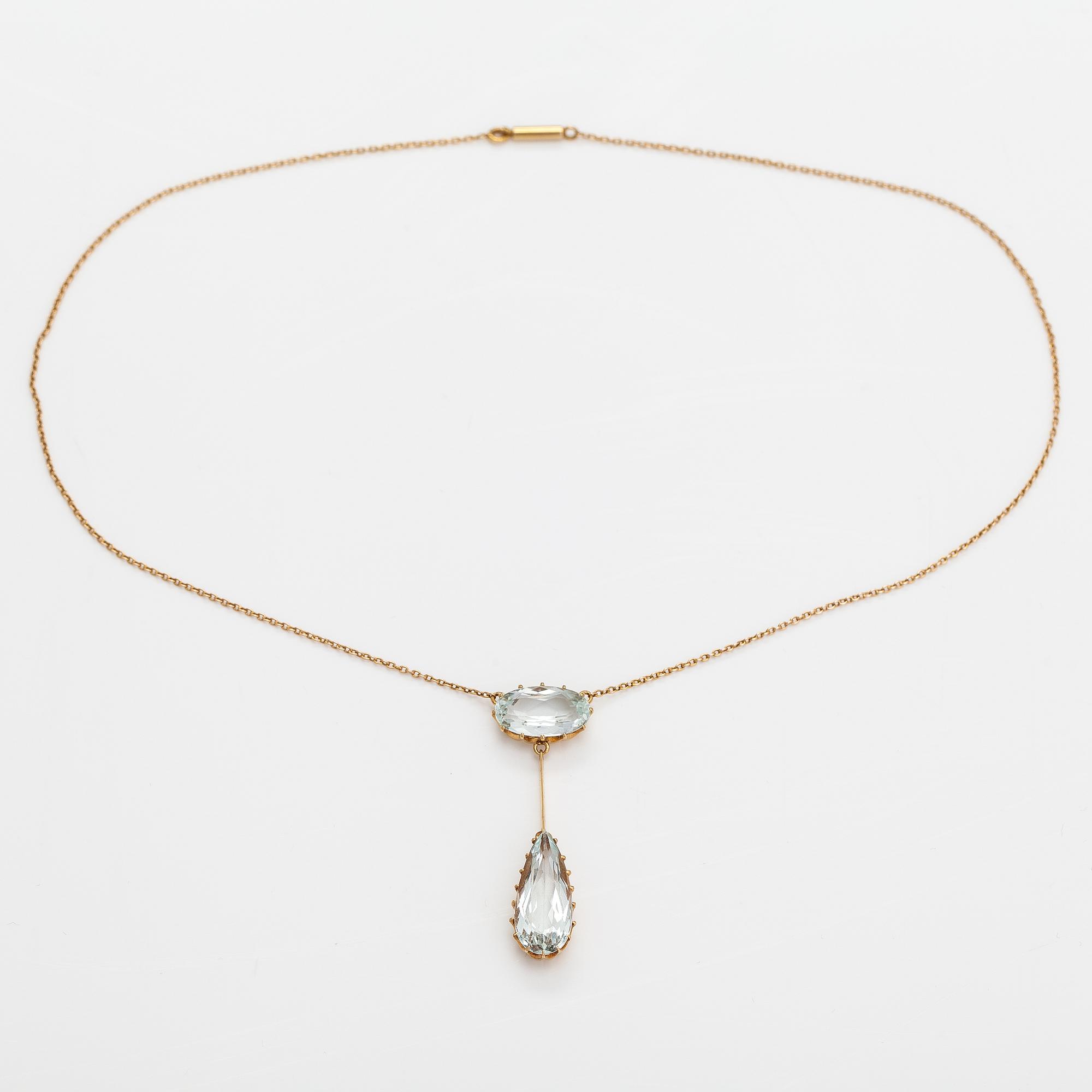 An 18K gold necklace with aquamarines.