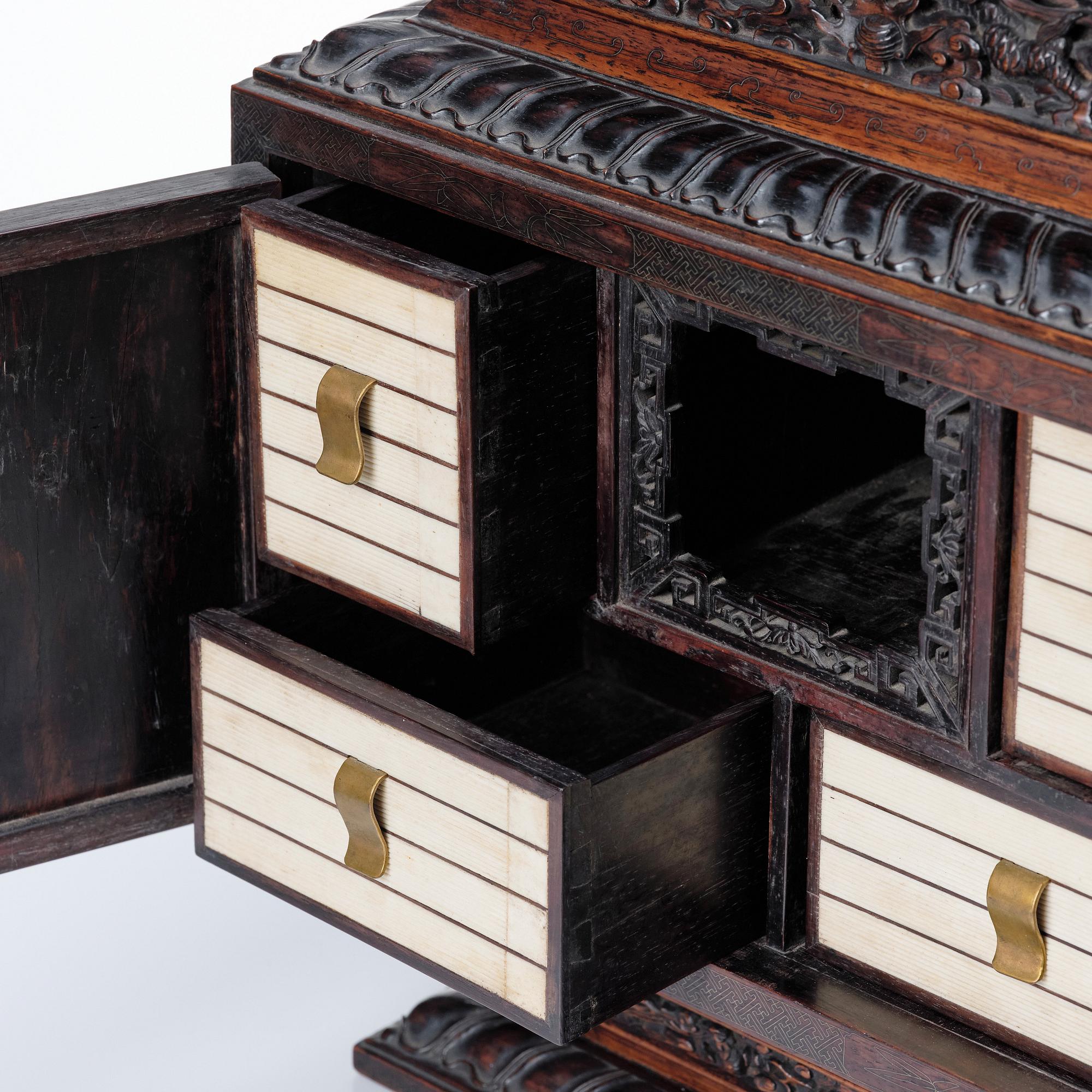 A hardwood dragon cabinet, Qing dynasty 18/19th Century.